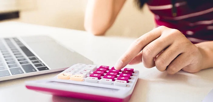 woman-at-desk-with-laptop-and-calculator